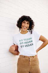 Cheerful vegan activist wearing a GO VEGAN shirt