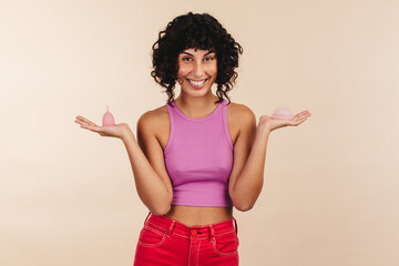 Woman holding two non-disposable sanitary products in her hands