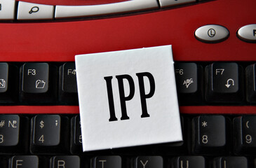IPP - abbreviation on a white sheet against the background of a computer keyboard
