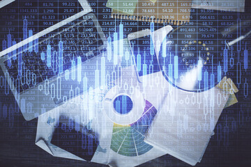 Financial market graph and top view computer on the desktop background. Multi exposure. Investment concept.
