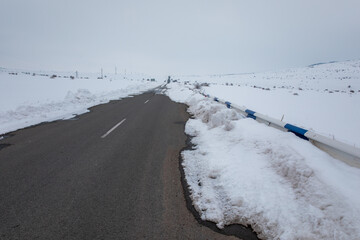 asphalt road with snowy landscape