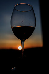 silhouette of a glass against a dramatic sky