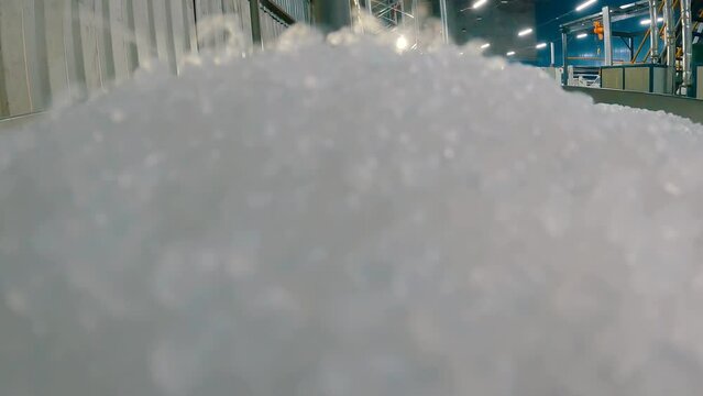 Polypropylene granules. Polypropylene granules are falling. Polypropylene granules close-up