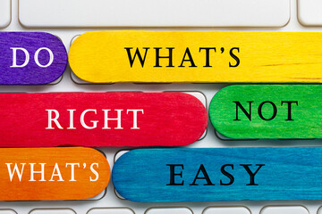 Colorful wooden sticks with word on a white keyboard. Motivational quote.