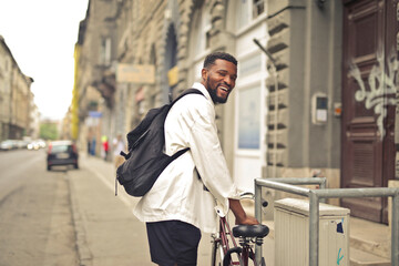 young man in the city with a  bike