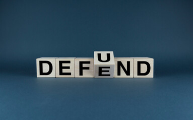 Cubes form words Defund or Defend. Defund and Defend concept