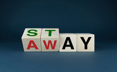 Cubes form the words Stay or Away. The concept of social problems and lifestyle