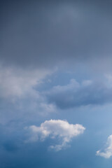 White cumulus clouds on a clear blue sky.