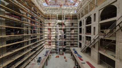 Panorama showing construction equipment material with scaffolding and tools inside the floor of high rising building timelapse, skyscraper. Building under construction. Interior work in progress.