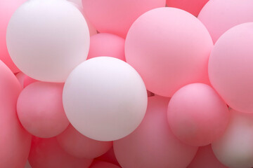 Texture of pink balloons as wall background. Balloons photo wall as party or wedding background. Invitation or photo zone, foil balls