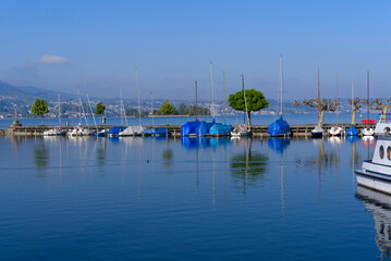 Fototapeta na wymiar Port at City of Rapperswil with port and scenic view over Lake Zürich on a sunny spring morning. Photo taken April 28th, 2022, Rapperswil, Switzerland.