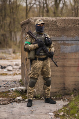 Soldier of the Armed Forces of Ukraine. Military man in tactical uniform with a machine gun in his hands