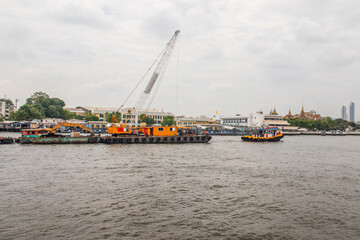 Tugboats with a cargo ship on the Chao Phraya River in Bangkok Thailand Southeast Asia