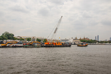 Fototapeta premium Tugboats with a cargo ship on the Chao Phraya River in Bangkok Thailand Southeast Asia