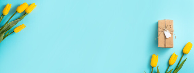 Mother's day background concept. Top view design of holiday greeting tulip flower bouquet on bright blue table background.
