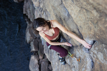 beautiful girl climbs the rock..