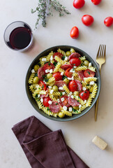 Salad with fusilli pasta, sausage, olives and cottage cheese. Italian food.
