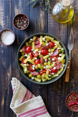 Salad with fusilli pasta, sausage, olives and cottage cheese. Italian food.