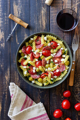 Salad with fusilli pasta, sausage, olives and cottage cheese. Italian food.