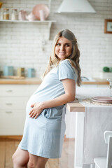 Smiling young morning female enjoying pregnancy awaiting baby relaxing having positive emotion