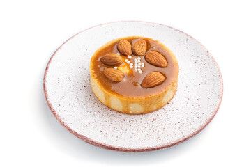 Sweet tartlets with almonds and caramel cream isolated on white background. side view.