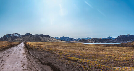 a gravel road across icland, on the way to landmannalaugar with its colorful mountains.