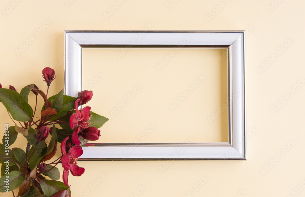 Sticker Beautiful flower arrangement. A branch of red flowers, an empty photo frame for text on a light pastel background. Wedding. birthday. Valentine's Day, Mother's Day. Top view, copy space