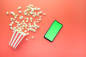 top view of smart phone and popcorn on table 