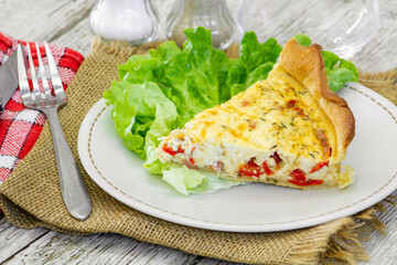 piece of vegetable quiche with salad on a plate
