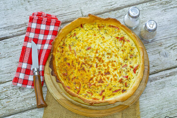 top view of quiche lorraine baked on wooden board