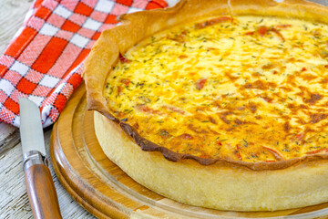 quiche lorraine cooked on a wooden board