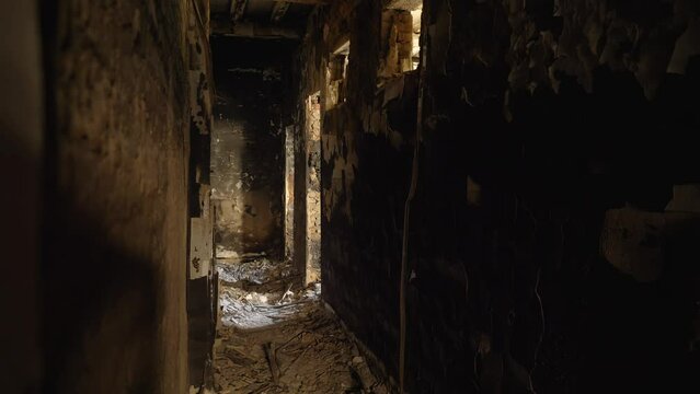 Inside a destroyed and burnt building. The result of an artillery or air-rocket attack by the Russian army on Ukraine. Aggression of the Russian Federation against democracy. Bombed civilian house