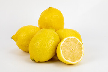 Fresh Meyer lemon, is a hybrid citrus fruit native to China. It is a cross between a citron and a mandarin pomelo hybrid, isolated in white background, shot in macro using studio setup. 