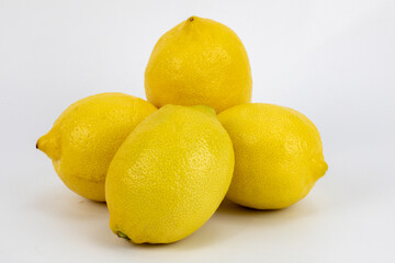 Fresh Meyer lemon, is a hybrid citrus fruit native to China. It is a cross between a citron and a mandarin pomelo hybrid, isolated in white background, shot in macro using studio setup. 