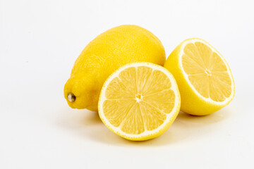 Fresh Meyer lemon, is a hybrid citrus fruit native to China. It is a cross between a citron and a mandarin pomelo hybrid, isolated in white background, shot in macro using studio setup. 