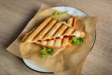 Sandwich with cheese tomatoes and greenary. Fast homemade delicious food