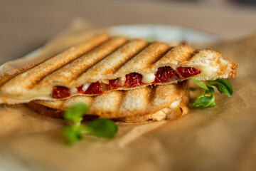 Sandwich with cheese tomatoes and greenary. Fast homemade delicious food