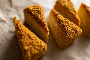 Sugar dessert on table. Baked cake with cream. Many pieces of cake