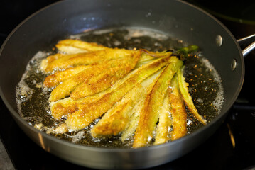 Eggplant fried in a pan in boiling oil. close up