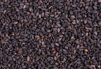 Black sesame seeds background. Organic spice. Top view.