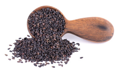 Black sesame seeds in wooden spoon, isolated on white background. Organic spice.