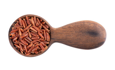 Red rice isolated in wooden spoon, on white background. Whole grain raw brown rice. Top view.