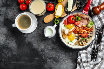 Healthy nutritious paleo keto breakfast diet. Full English breakfast in pan fried eggs, bacon, beans, toasts and coffee. Keto breakfast or lunch. banner, catering menu recipe place for text, top view.