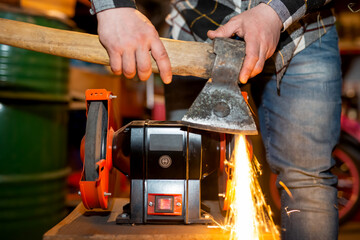 The process of sharpening an ax with the release of a large number of bright sparks