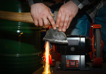 The process of sharpening an ax with the release of a large number of bright sparks