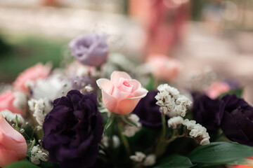 Bouquet of flowers. Blurred background. Pink roses, purple roses, white flowers