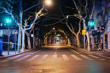 Fotobehang SHANGHAI, CHINA - APRIL 12, 2022: The empty street at night in lockdown © Nico de Rouge