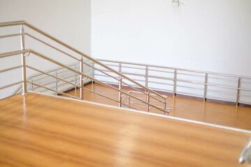 Modern brown staircase, walkway up the building building, aluminum steel railing