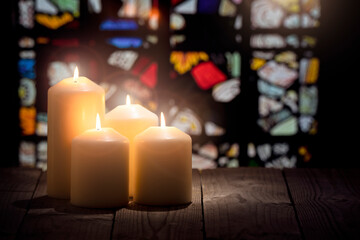 Candles burning in a church background