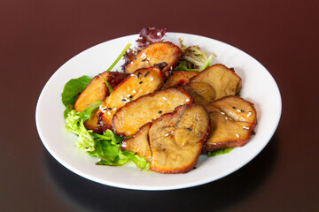 Chashu with salads of traditional Cantonese yum-cha Asian gourmet cuisine meal food dish on the white serving plate and brown red table